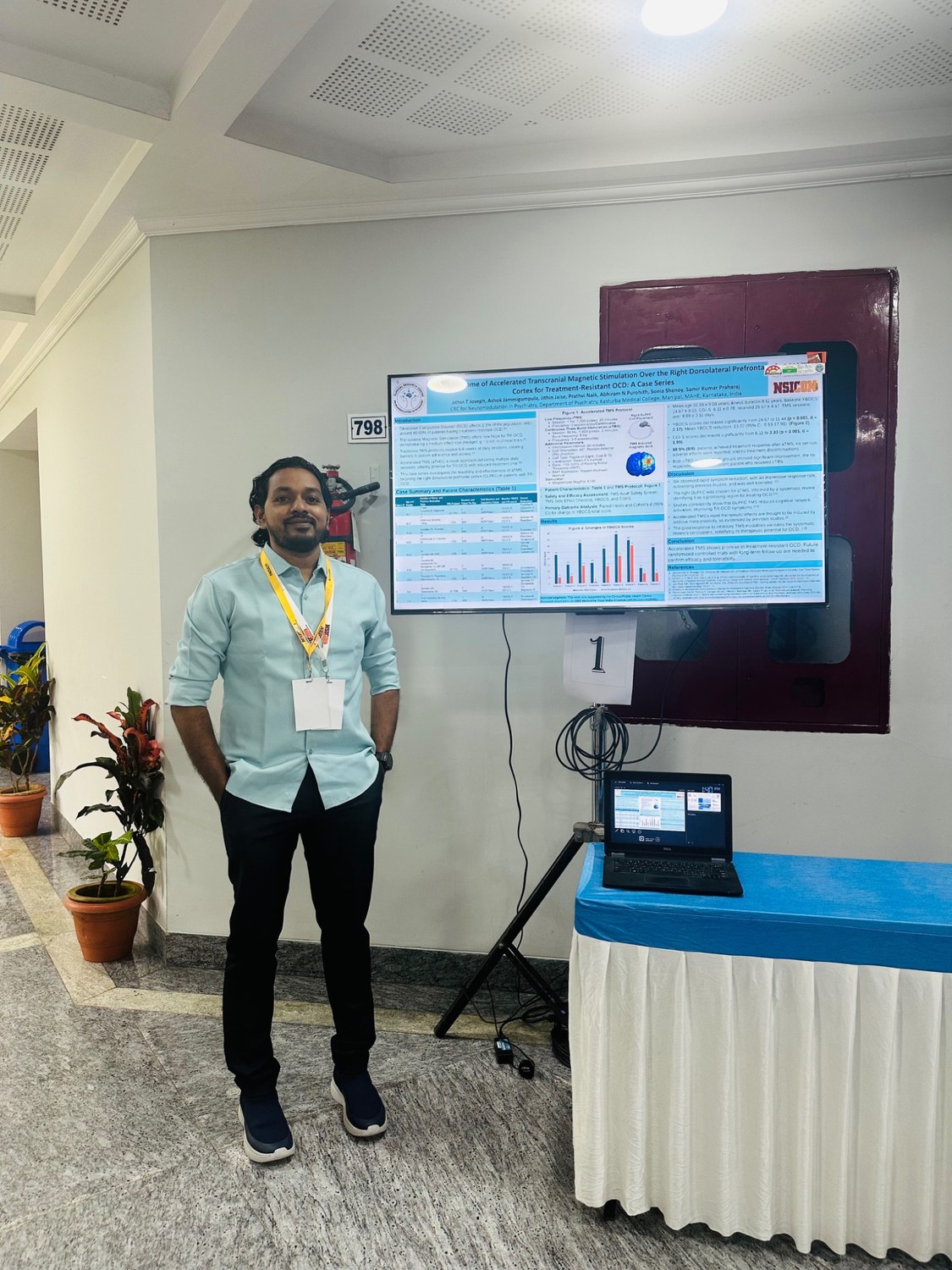 Jithin Joseph beside a scientific research poster